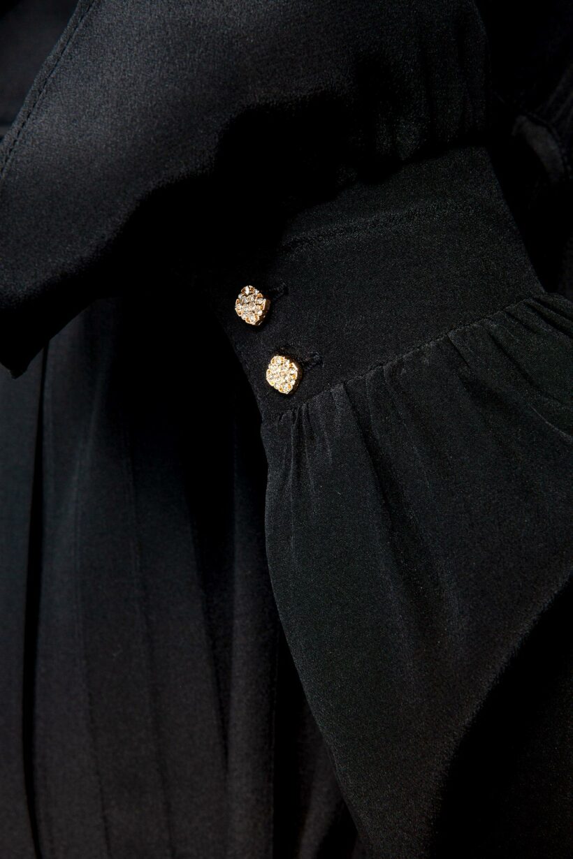 IVI collection black blouse with pleat detail in the font and back with a golden details made from silk and ruffle details on the sleeve from aw24 collection