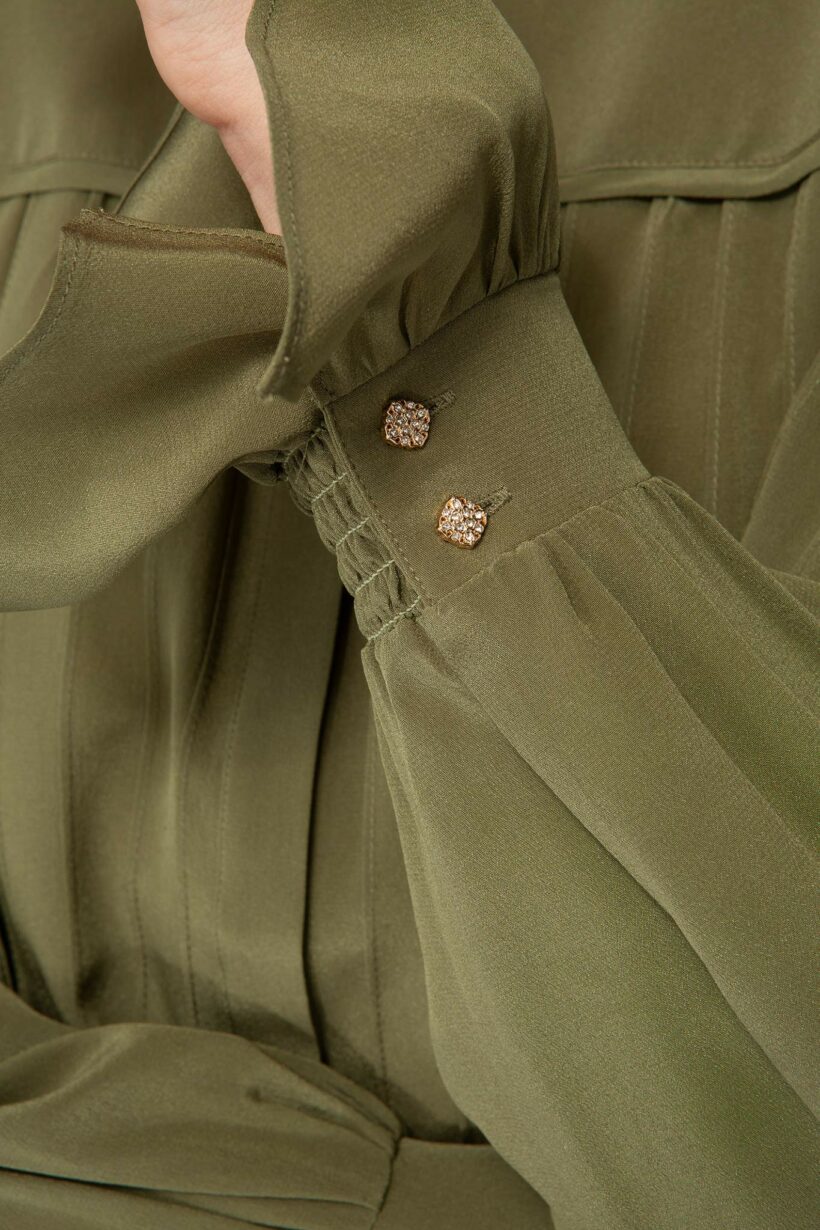 IVI collection olive green blouse with pleat detail in the font and back with a golden button at the top made from 100% silk from aw24 collection