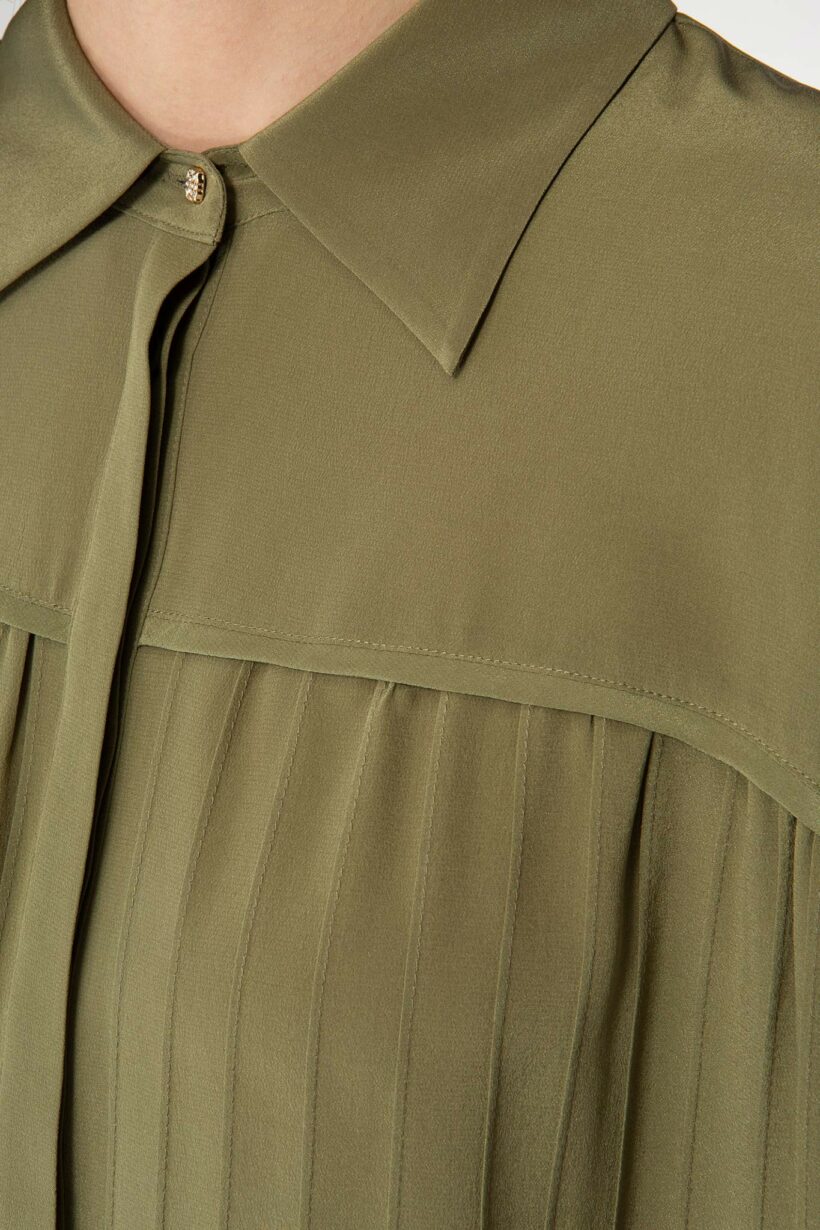 IVI collection olive green blouse with pleat detail in the font and back with a golden button at the top made from 100% silk from aw24 collection